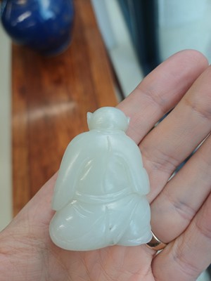 Lot 89 - A Chinese pale celadon jade 'zodiac' carving, Qing dynasty