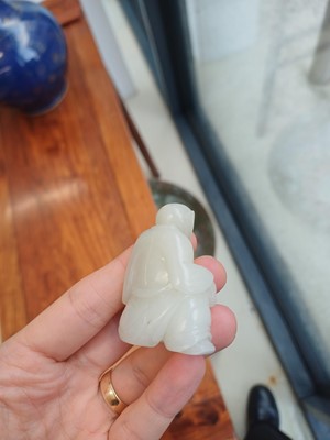 Lot 89 - A Chinese pale celadon jade 'zodiac' carving, Qing dynasty