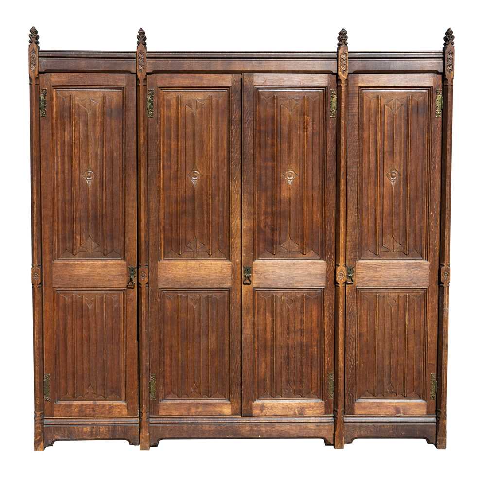 Lot 65 - A Pugin style ecclesiastical four door oak linen cupboard