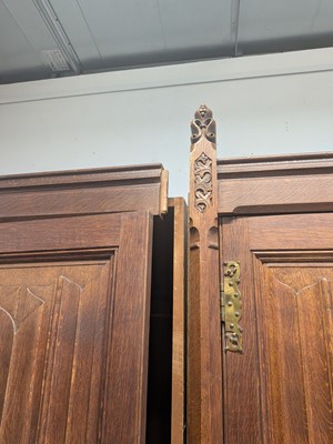 Lot 65 - A Pugin style ecclesiastical four door oak linen cupboard