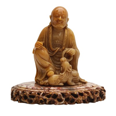 Lot 241 - A fine Chinese carved soapstone figure of a Luohan, Qing dynasty, attributed to Zhou Bin