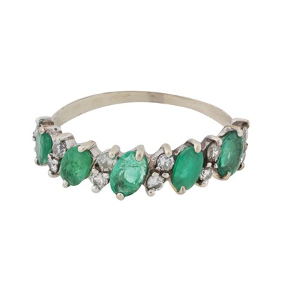 Lot 115 - An emerald and diamond half eternity ring