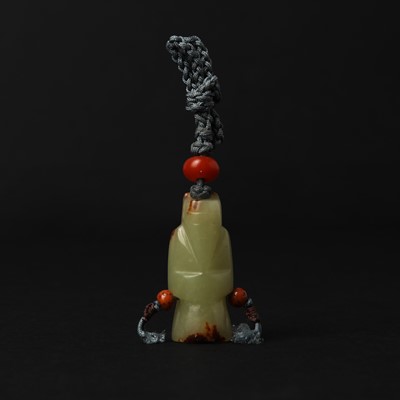 Lot 152 - A Chinese archaistic celadon jade 'figure' pendant, 19th/20th century