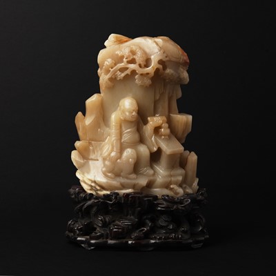 Lot 137 - A large Chinese 'Luohan and grotto' jade group, 19th century