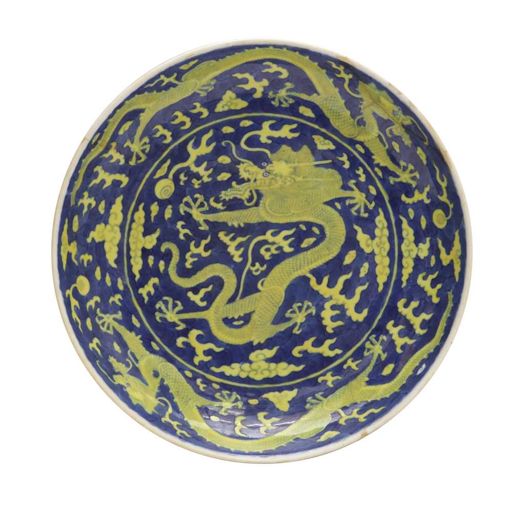 Lot 65 - A rare Chinese yellow-enamelled blue-ground 'dragon' dish, Qing dynasty, Daoguang period