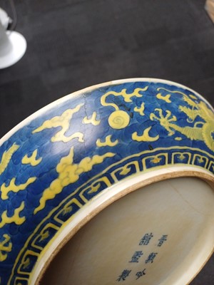 Lot 65 - A rare Chinese yellow-enamelled blue-ground 'dragon' dish, Qing dynasty, Daoguang period