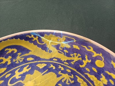 Lot 65 - A rare Chinese yellow-enamelled blue-ground 'dragon' dish, Qing dynasty, Daoguang period