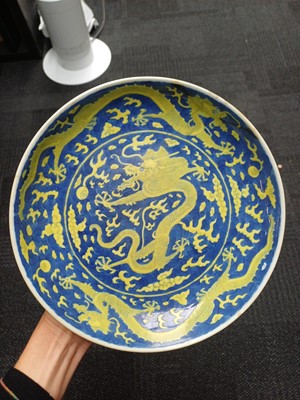 Lot 65 - A rare Chinese yellow-enamelled blue-ground 'dragon' dish, Qing dynasty, Daoguang period