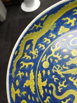 Lot 65 - A rare Chinese yellow-enamelled blue-ground 'dragon' dish, Qing dynasty, Daoguang period