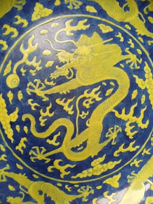 Lot 65 - A rare Chinese yellow-enamelled blue-ground 'dragon' dish, Qing dynasty, Daoguang period