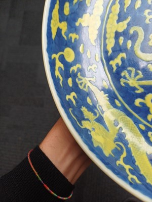 Lot 65 - A rare Chinese yellow-enamelled blue-ground 'dragon' dish, Qing dynasty, Daoguang period