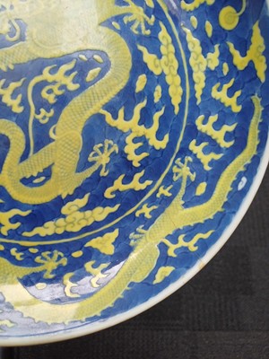 Lot 65 - A rare Chinese yellow-enamelled blue-ground 'dragon' dish, Qing dynasty, Daoguang period