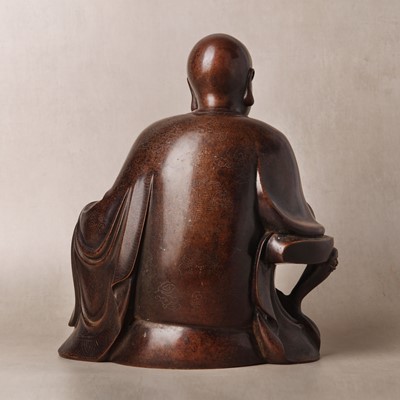 Lot 75 - A Chinese silver-inlaid bronze figure of a Luohan, late Qing dynasty
