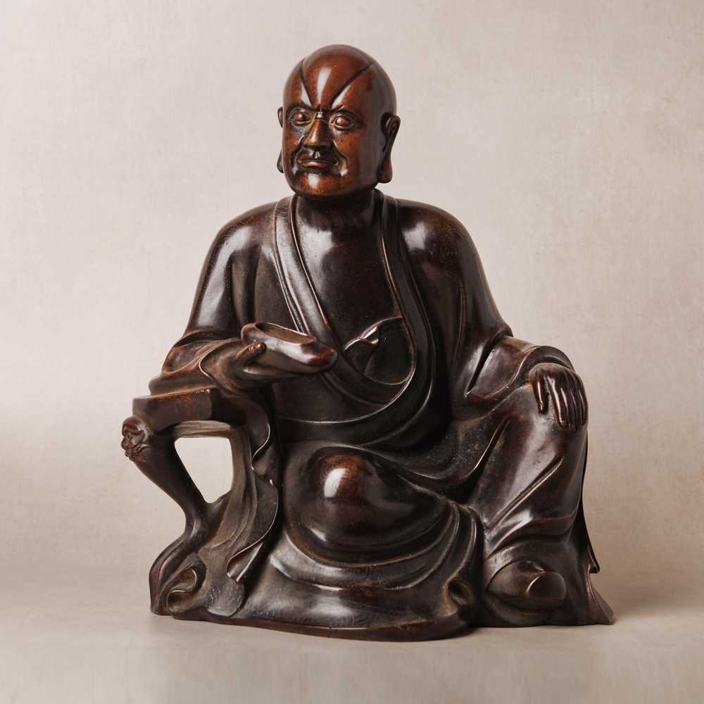 Lot 75 - A Chinese silver-inlaid bronze figure of a Luohan, late Qing dynasty