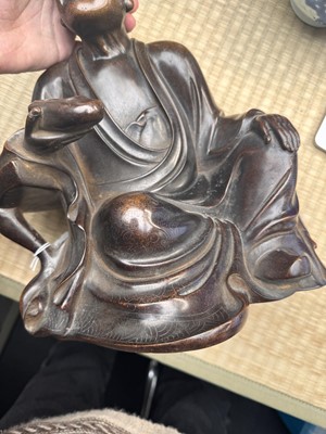 Lot 75 - A Chinese silver-inlaid bronze figure of a Luohan, late Qing dynasty