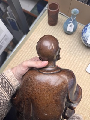 Lot 75 - A Chinese silver-inlaid bronze figure of a Luohan, late Qing dynasty