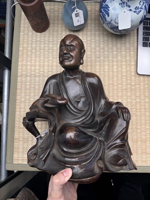 Lot 75 - A Chinese silver-inlaid bronze figure of a Luohan, late Qing dynasty