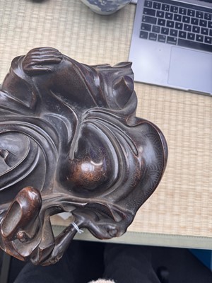 Lot 75 - A Chinese silver-inlaid bronze figure of a Luohan, late Qing dynasty