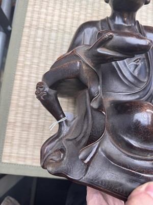 Lot 75 - A Chinese silver-inlaid bronze figure of a Luohan, late Qing dynasty