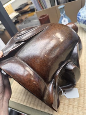 Lot 75 - A Chinese silver-inlaid bronze figure of a Luohan, late Qing dynasty