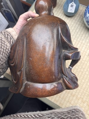 Lot 75 - A Chinese silver-inlaid bronze figure of a Luohan, late Qing dynasty