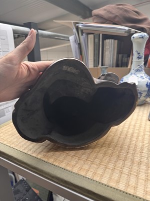 Lot 75 - A Chinese silver-inlaid bronze figure of a Luohan, late Qing dynasty