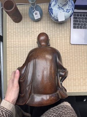 Lot 75 - A Chinese silver-inlaid bronze figure of a Luohan, late Qing dynasty