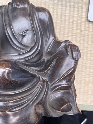 Lot 75 - A Chinese silver-inlaid bronze figure of a Luohan, late Qing dynasty