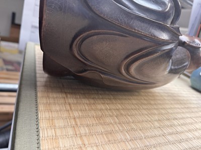 Lot 75 - A Chinese silver-inlaid bronze figure of a Luohan, late Qing dynasty