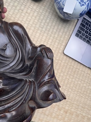 Lot 75 - A Chinese silver-inlaid bronze figure of a Luohan, late Qing dynasty