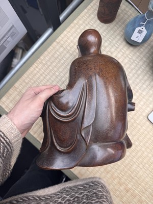 Lot 75 - A Chinese silver-inlaid bronze figure of a Luohan, late Qing dynasty