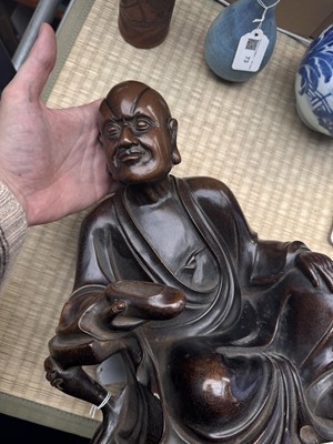 Lot 75 - A Chinese silver-inlaid bronze figure of a Luohan, late Qing dynasty