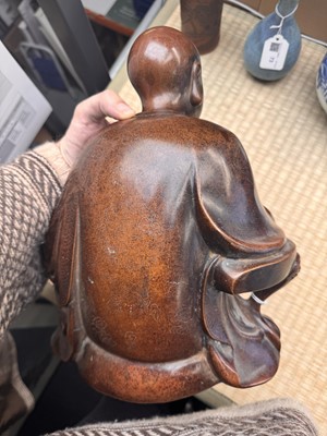 Lot 75 - A Chinese silver-inlaid bronze figure of a Luohan, late Qing dynasty