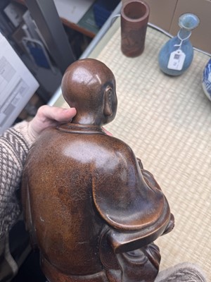 Lot 75 - A Chinese silver-inlaid bronze figure of a Luohan, late Qing dynasty