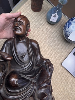 Lot 75 - A Chinese silver-inlaid bronze figure of a Luohan, late Qing dynasty