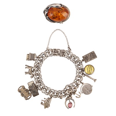 Lot 329 - A charm bracelet and an amber brooch