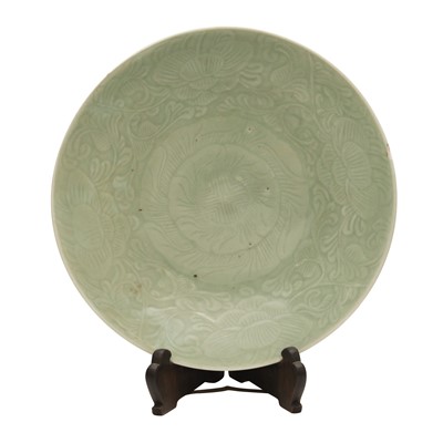 Lot 283 - A Chinese celadon-glazed 'blossoms' dish, Qing dynasty, 19th century