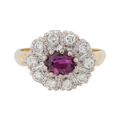Lot 180 - A ruby and diamond halo ring, circa 1975