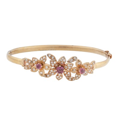 Lot 50 - A ruby and diamond flower bangle