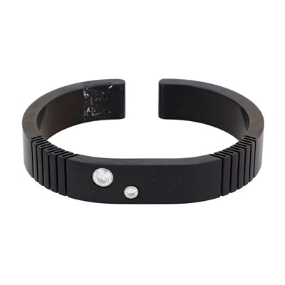 Lot 368 - A black titanium and cubic zirconia bangle