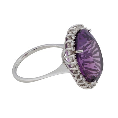 Lot 348 - An amethyst and sapphire halo ring