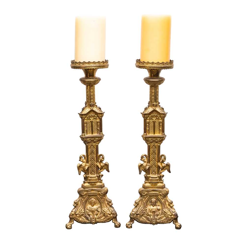 Lot 73 - A pair of Reformed Gothic gilt brass altar candlesticks, late 19th century