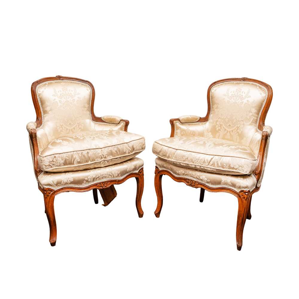 Lot 4 - A pair of Louis XV style walnut bergère armchairs