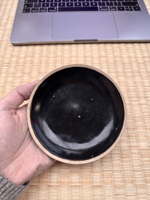 Lot 19 - A Chinese Henan black-glazed washer, Song dynasty