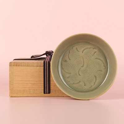 Lot 37 - A fine Chinese Yaozhou celadon 'waves' carved dish, Northern Song dynasty