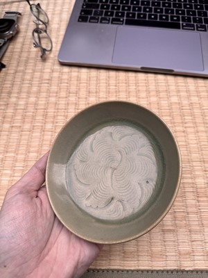 Lot 37 - A fine Chinese Yaozhou celadon 'waves' carved dish, Northern Song dynasty