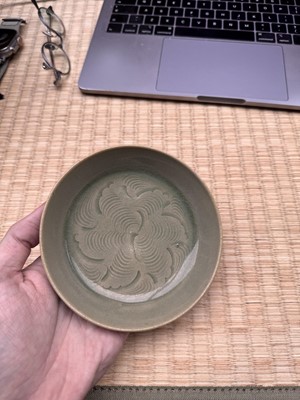 Lot 37 - A fine Chinese Yaozhou celadon 'waves' carved dish, Northern Song dynasty