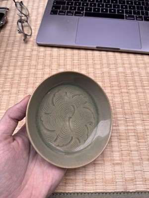 Lot 37 - A fine Chinese Yaozhou celadon 'waves' carved dish, Northern Song dynasty