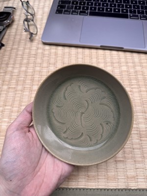 Lot 37 - A fine Chinese Yaozhou celadon 'waves' carved dish, Northern Song dynasty