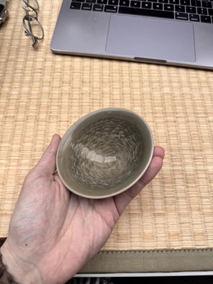 Lot 40 - A small Chinese Yaozhou celadon 'fish' moulded bowl, Northern Song dynasty